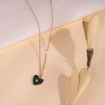 "Heart-shaped green emerald pendant symbolizing elegance and love"