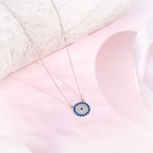 "Elegant evil eye necklace with a sapphire halo and silver chain"