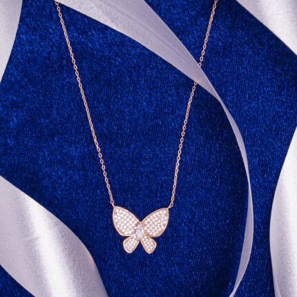 "Elegant butterfly charm necklace in polished rose gold finish"