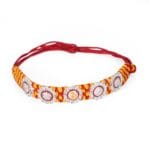 Om Shining Rakhi – Handwoven Thread with Silver & Stone Floral Charms